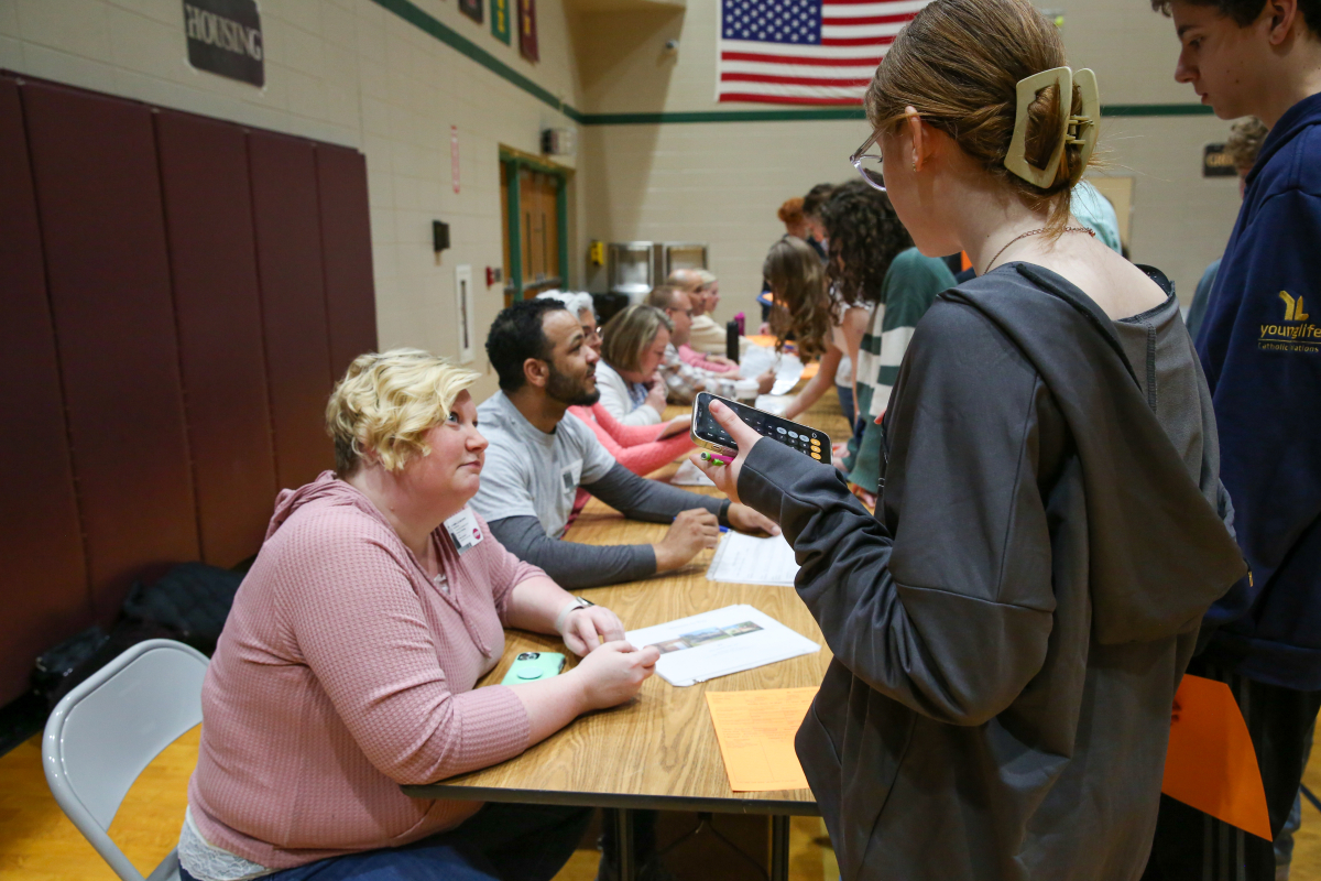 students talks to parent volunteer