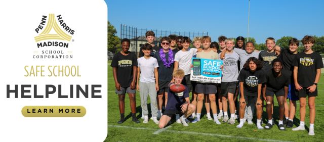 The team is posing on a football field.