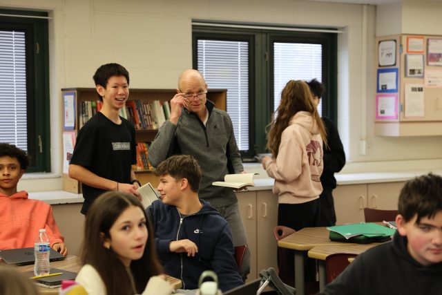 Man in classroom looks surprised