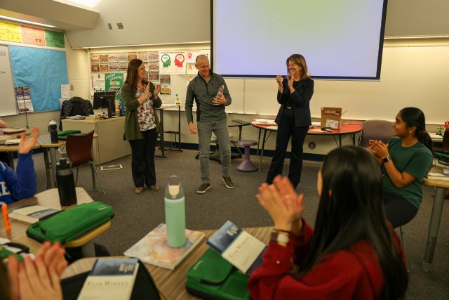 Man in classroom being recognized with award