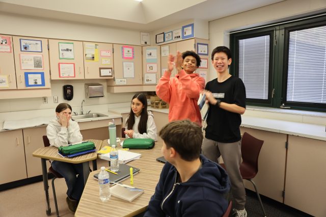 students in classroom applaud